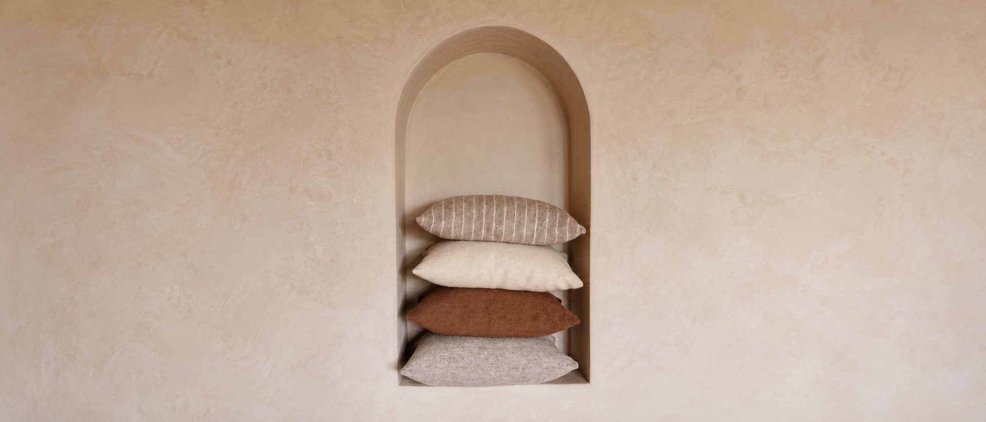 Soft pillows layered together in a comfortable setting